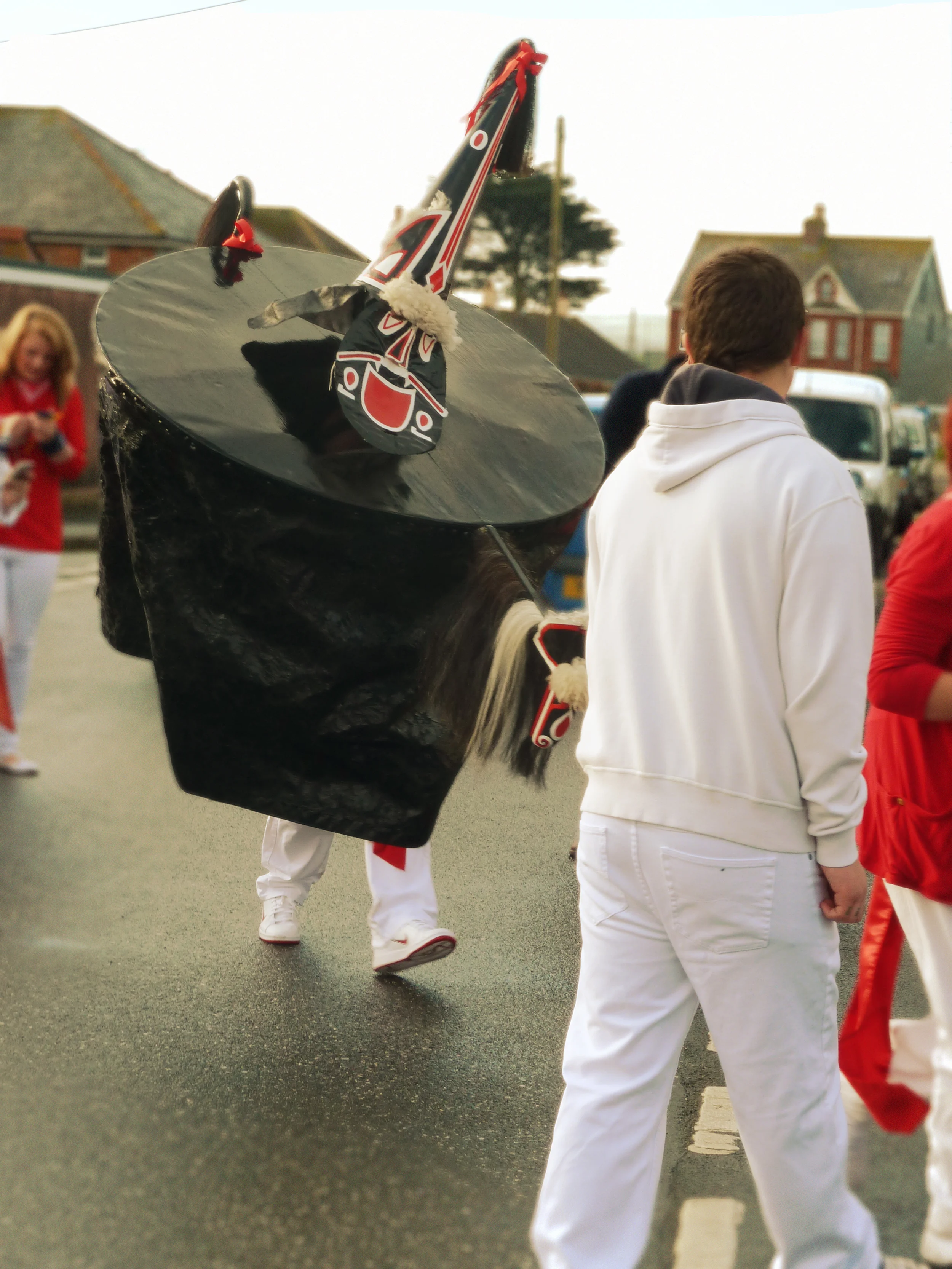 The Old Oss out for the Children's parade at dawn (around 6am). There is no word of irony or humour in the presence of the red and white Nike trainers, but rather demonstration of the degree of dedication to which the participants approach this festival.