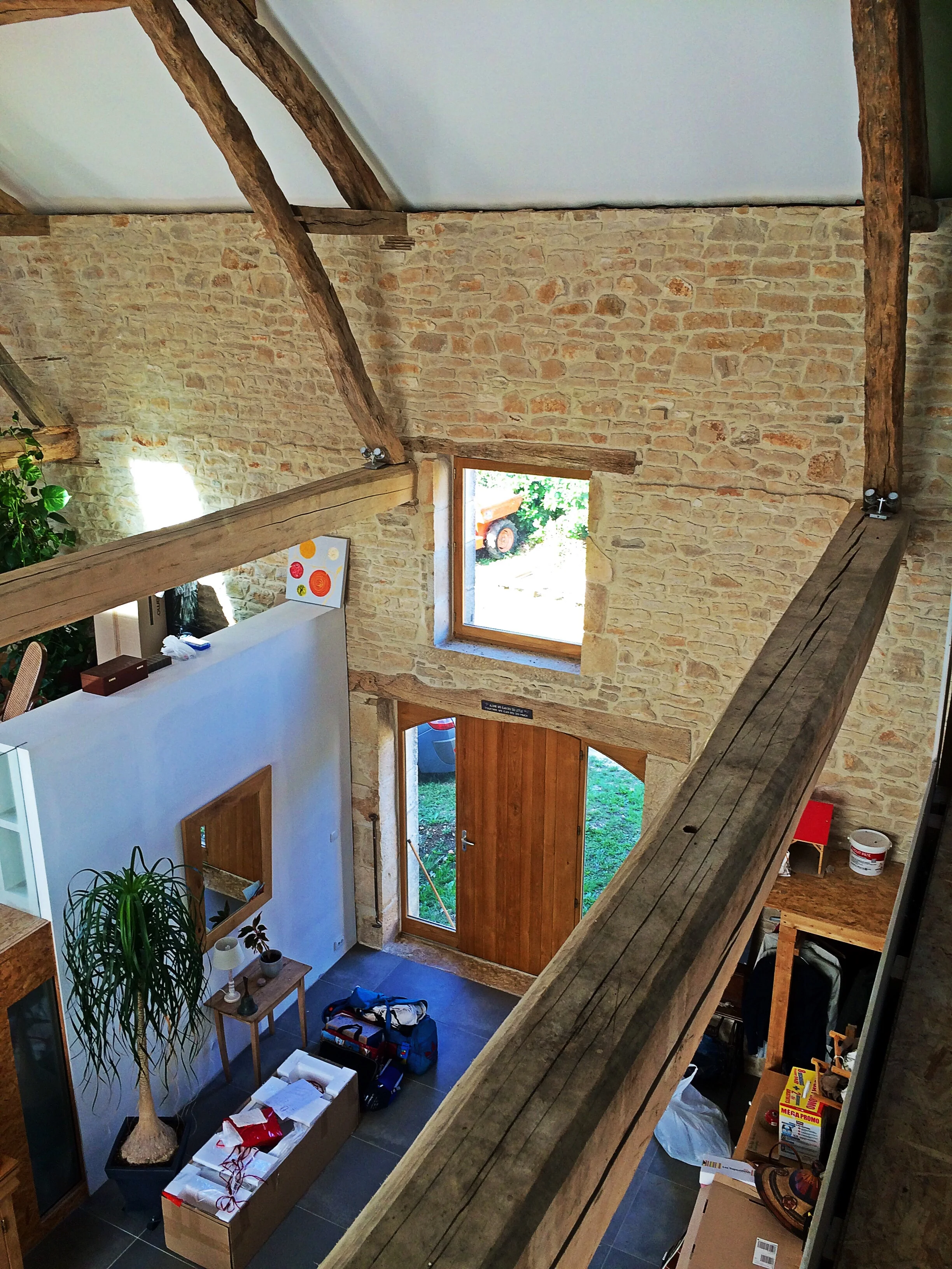 The existing roof timbers and stone walling are offset by contemporary insertions