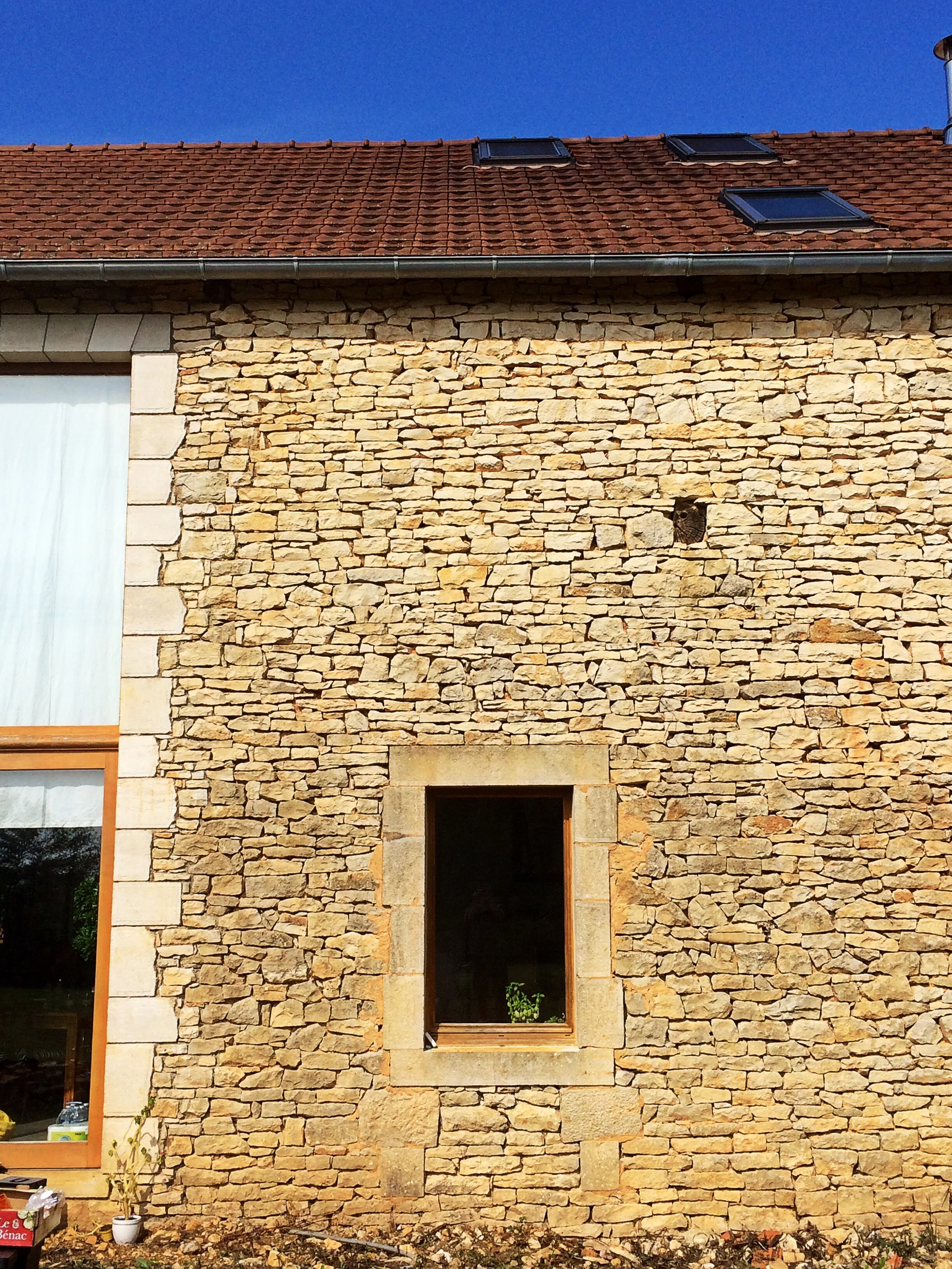The exterior shell retains its barn-like simplicity