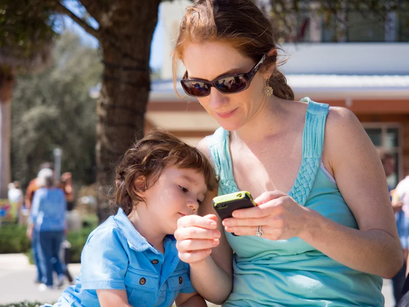 Juan's wife and son relaxing in the shade after taking in the sights at a local car show.