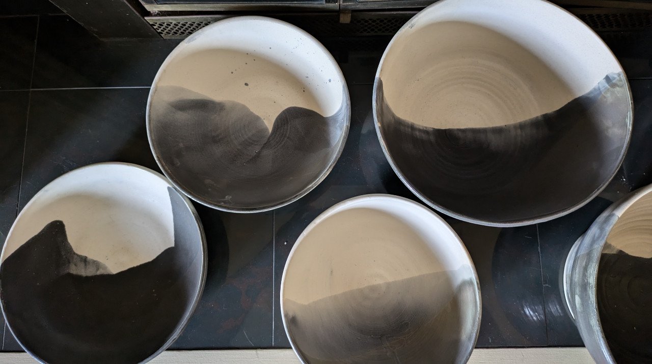Large hand thrown ceramic bowls with black and white shino glaze.