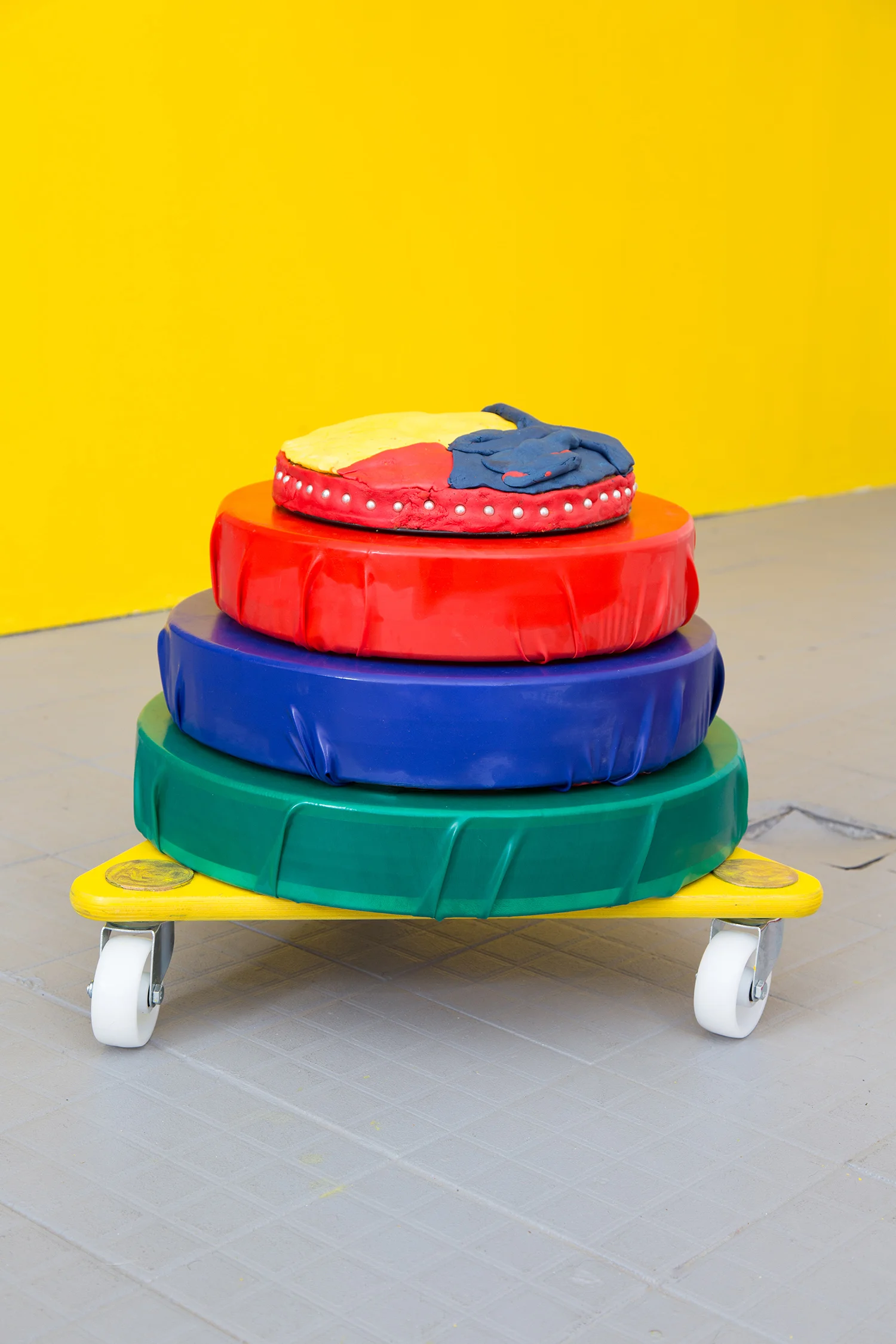 RGB Yellowcake 4/4 Materials: Ocean drums with ball bearings (internal), wooden moving trolley, latex, spray paint, gouache and acrylic paint, vanilla cake, yellow food colouring, silver sugar pearls, fondant Mobile sculpture dimensions: 1.5 metre x 1 metre