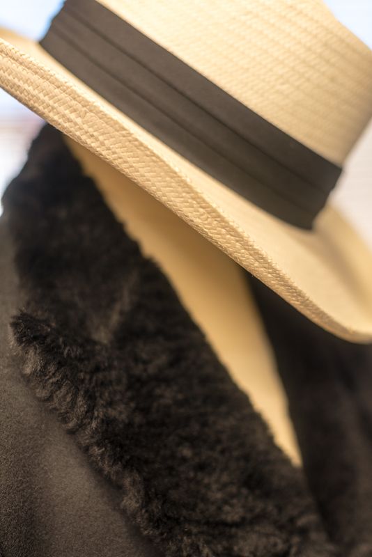 The black wool Bumble Bee jacket trimmed with Toscana lamb fleece and styled with a "Gambler" straw hat.