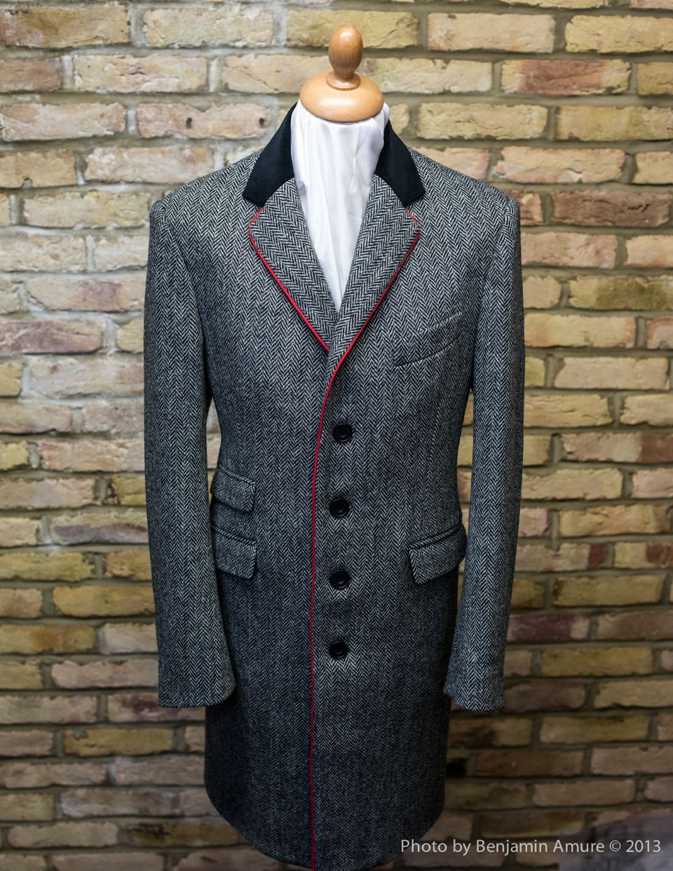 The "Jay B" overcoat in Harris tweed with black velvet collar and red piping. Lined in cornflower blue silk screen printed with the Bedlam handcuffs.