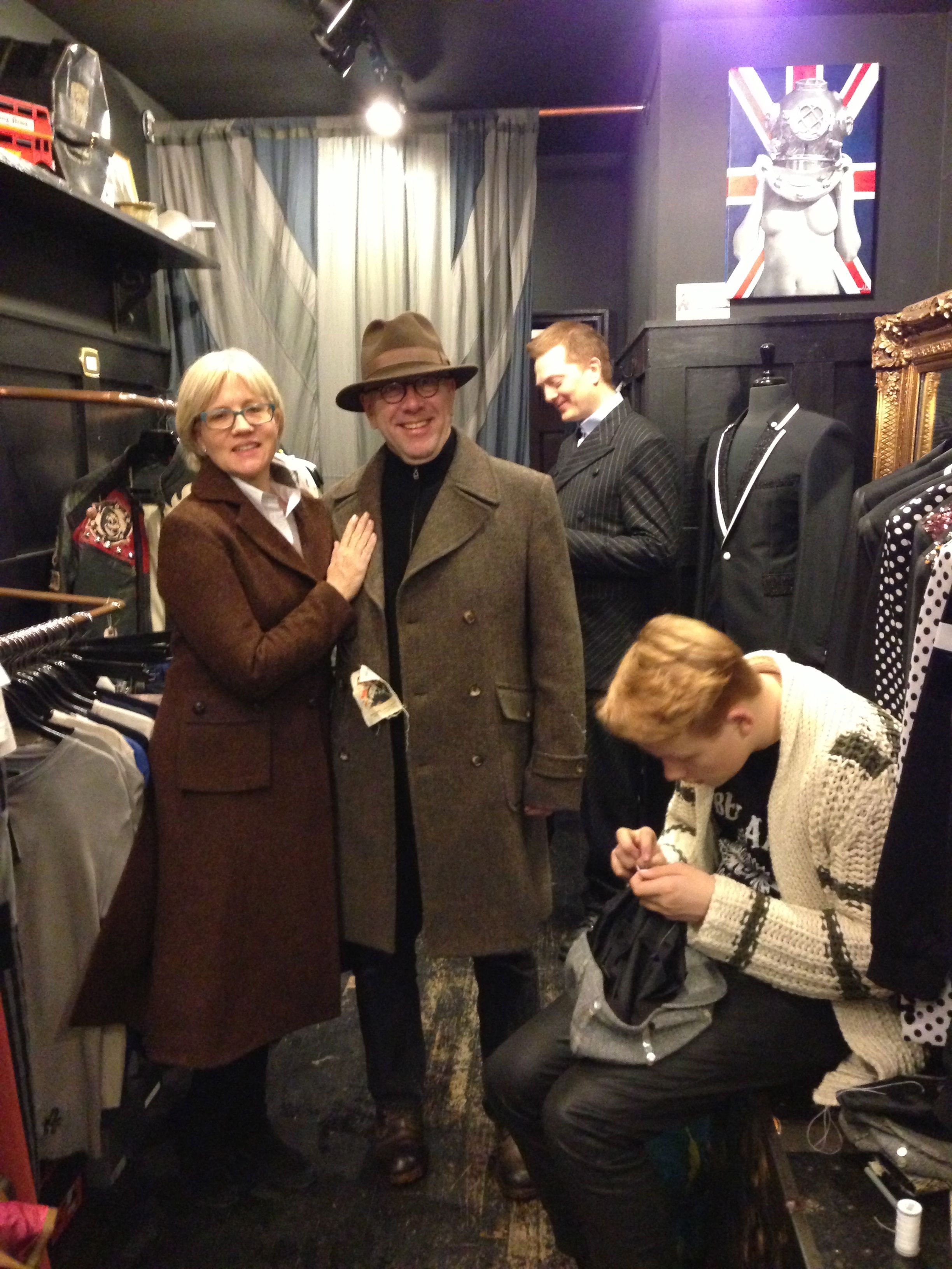Helen Patton in the coat of Harris Tweed named for her, whilst our then intern, her eldest son Ingmar, sews pearly buttons on Bedlam's London-New York Newsboy Cap.
