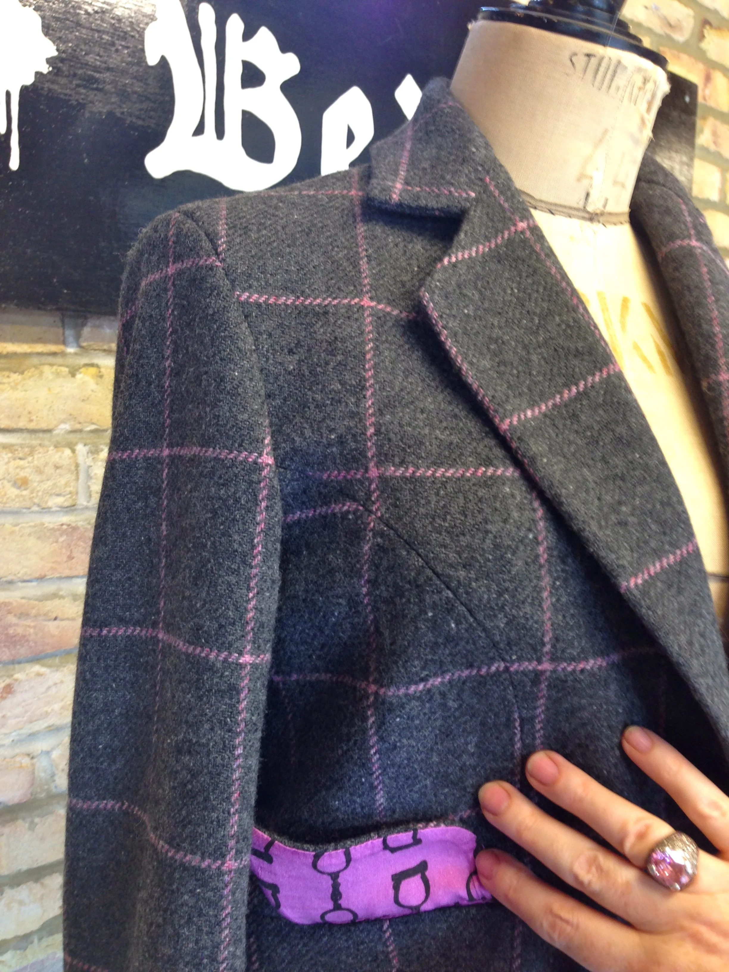  Silk lining custom printed in the pink of the check with our signature handcuff motif. 