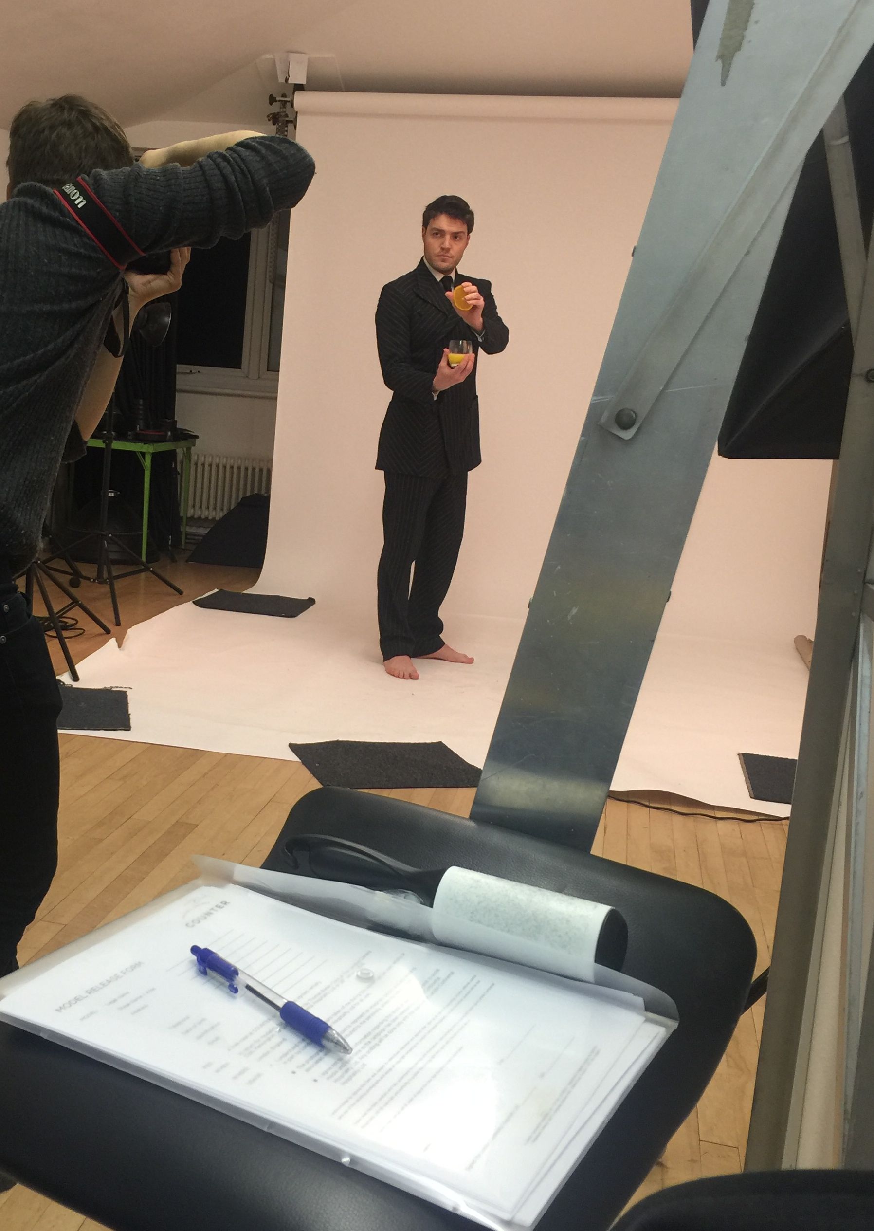 Tom Burke squeezing with intent at the photo shoot to celebrate 1st anniversary of the Vauxhall restaurant Counter, wearing his grey flannel Tectonic suit