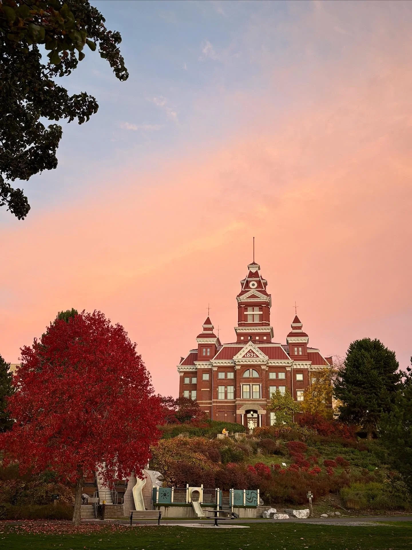 I was struck by the sunset colors in the sky tonight while I was driving, so I pulled over to capture it. Then I turned around and saw the clouds lit up behind our historic museum and was able to capture the beauty of the building with the sunset col