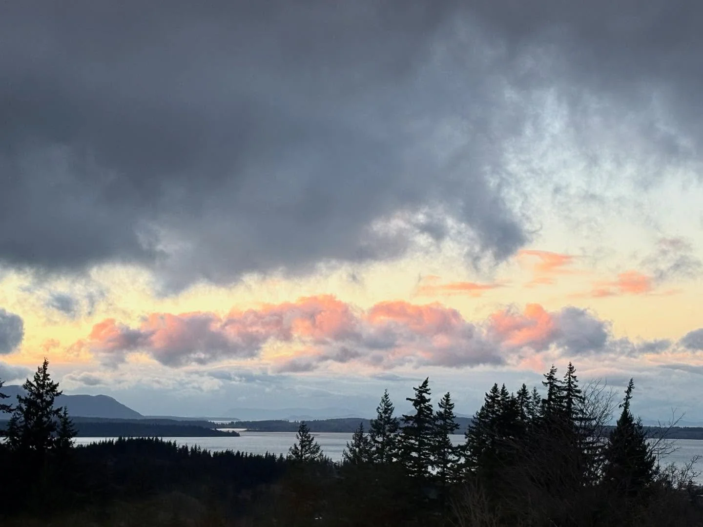 Last night&rsquo;s sunset (12/07) was a stunner! A row of puffy clouds lit up brightly over the islands while the surrounding clouds were moody and gray. The photos look like paintings!! It was a beautiful end to the day, the calm break needed before