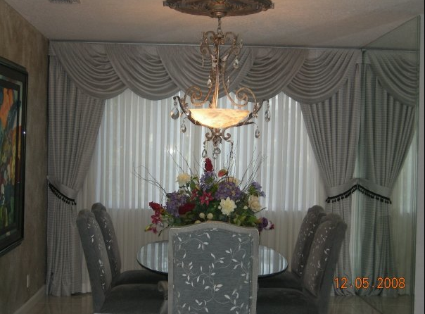SWAGS:
A graceful drape of fabric that hang in semicircular folds across the top of a window. They can be mounted from either a rod or a board. CASCADES: Pleated or gathered side panels that descend in a zig-zag pattern from a drapery heading or top treatment. They are lined with a contrasting fabric or are self-lined. They can be placed over the top of the swags or underneath them. Also called jabots.