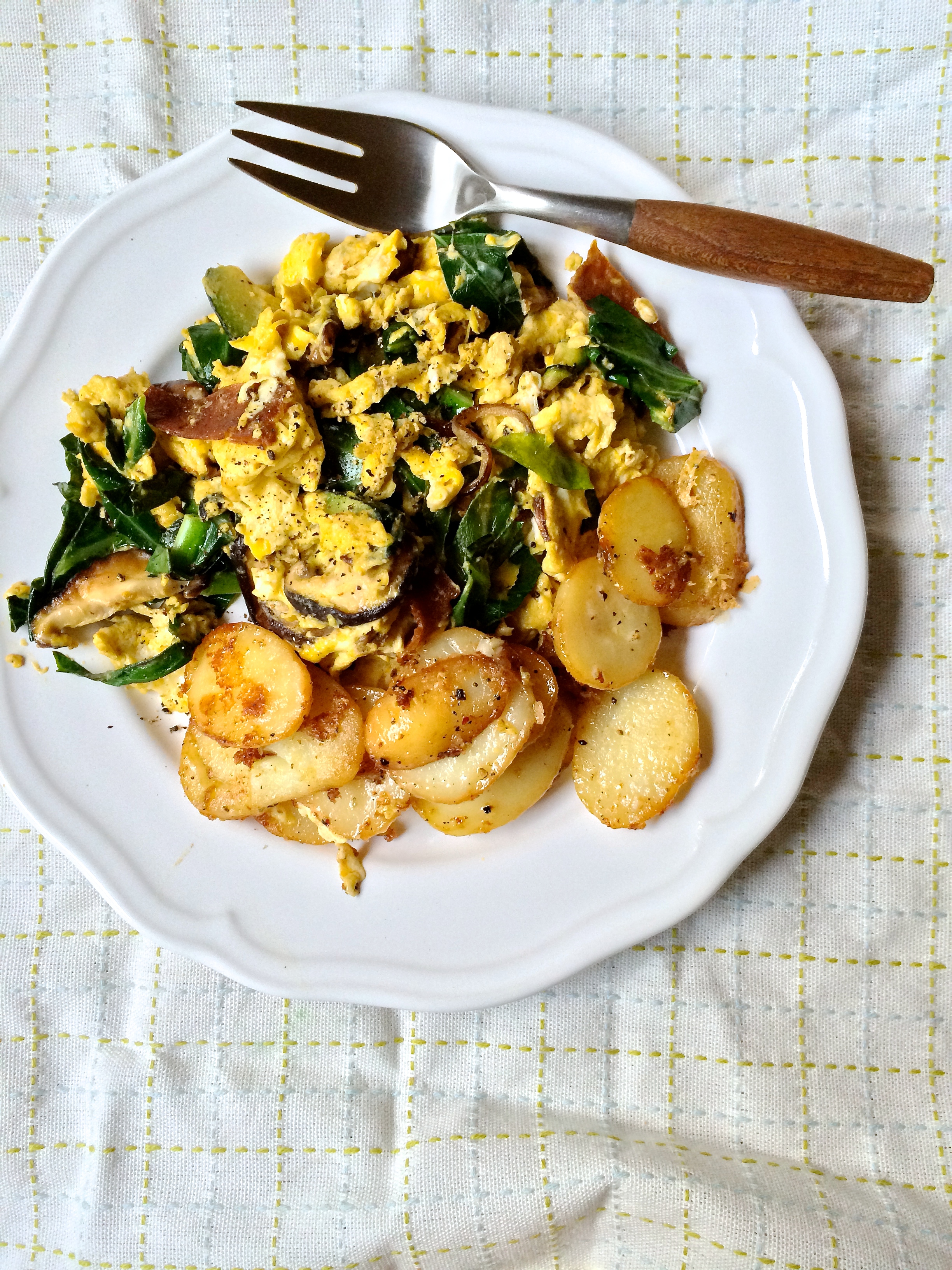 Scrambled fresh eggs with collard greens, seitan bacon and shiitake mushrooms and a side of garlic parmesan potatoes.