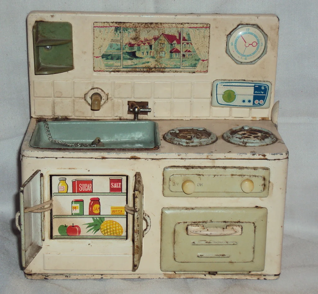 Battery-operated tin kitchen. This one is a little beaten up, but when you turn the tap on, water flows and the gas burner "fires" up. via ebay
