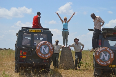 Border stone, one foot in Kenya, one foot in Tanzania