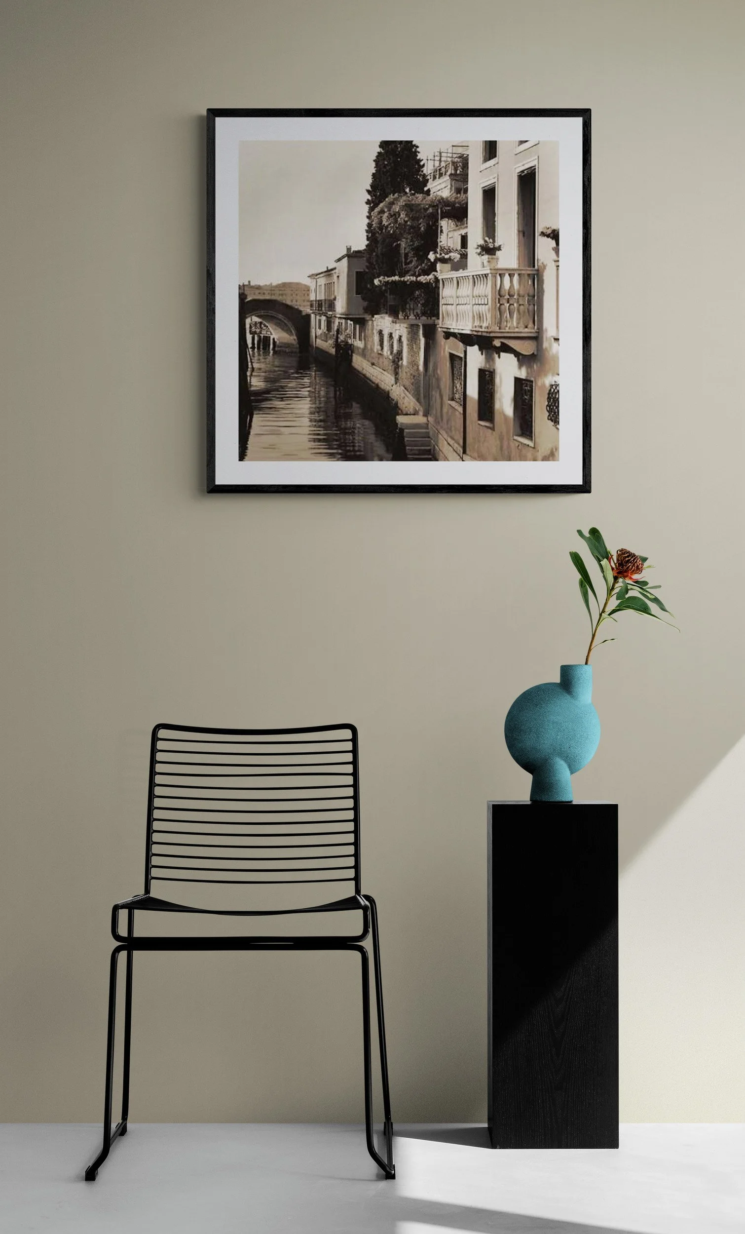 Black_wire_chair_next_to_plant_on_plinth.jpg