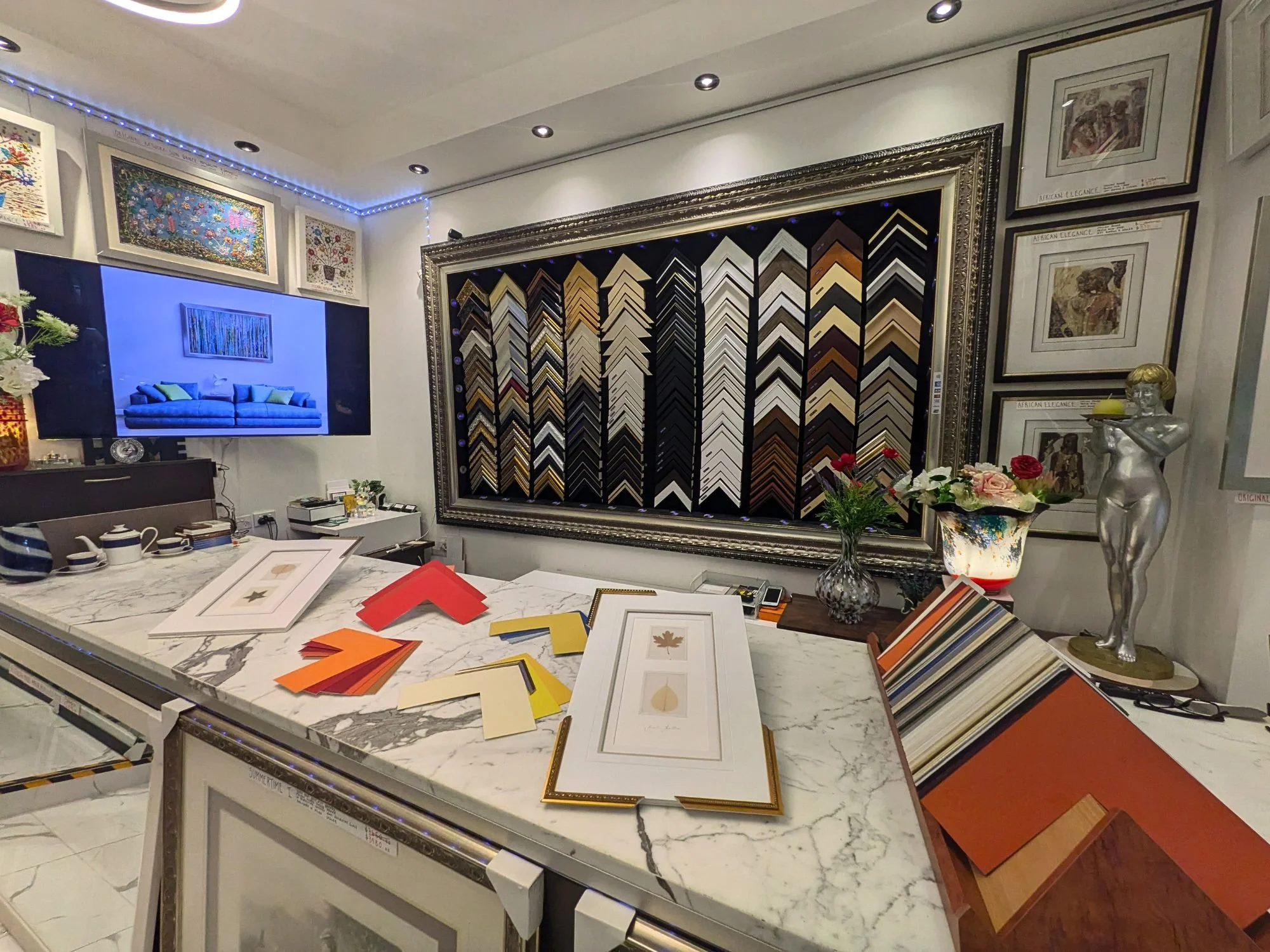 "Custom frame and matting samples displayed on a marble counter at Art Reflection gallery in Mosman, Sydney."