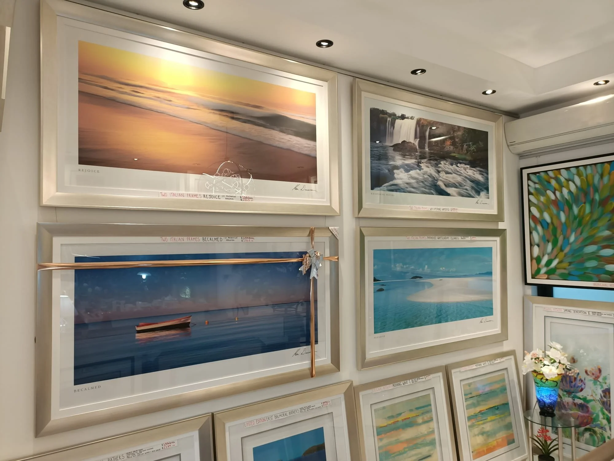 Gallery wall at Art Reflection in Mosman displaying a collection of framed coastal and landscape art prints.