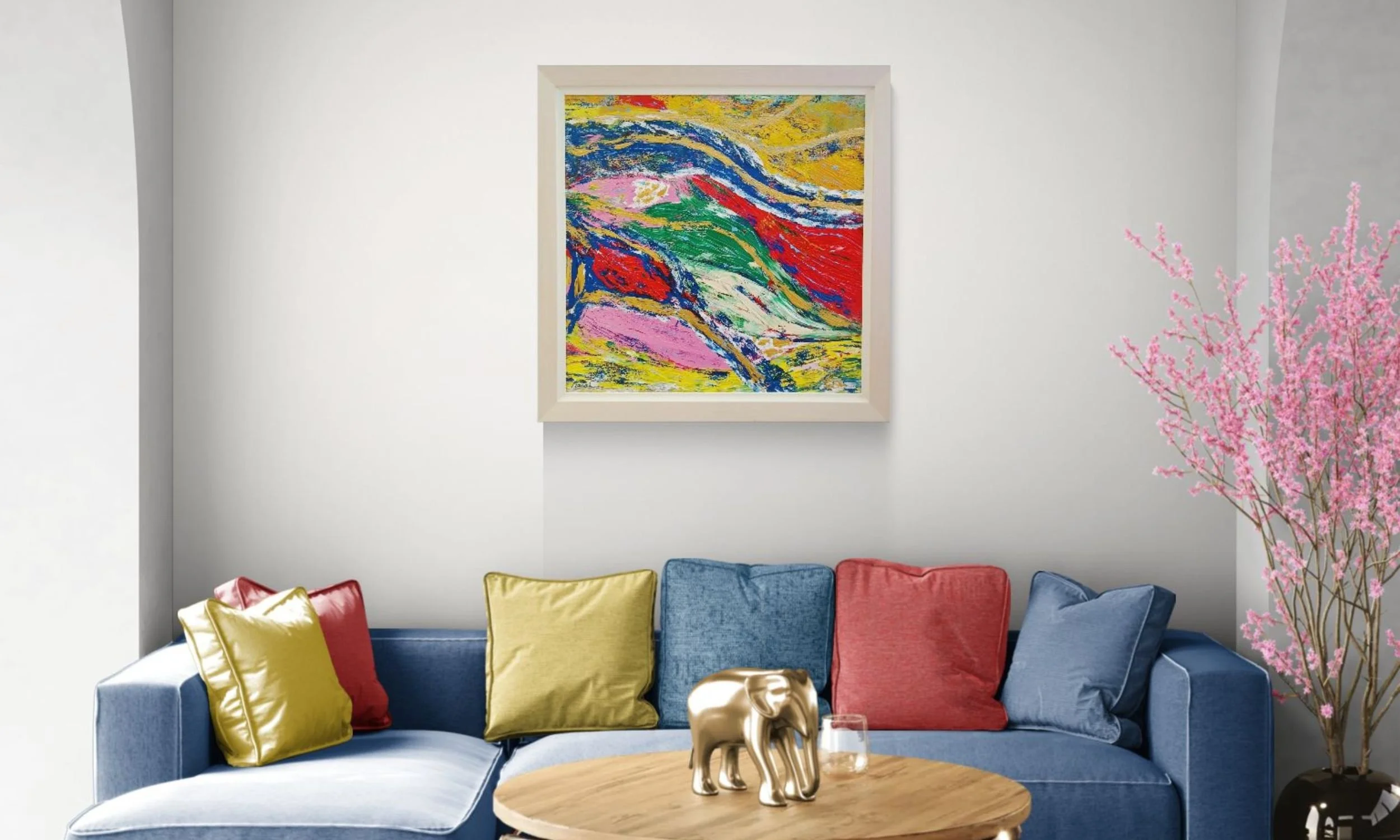 "A large, framed original abstract artwork hanging above an olive green sofa in a bright, modern living room setting."