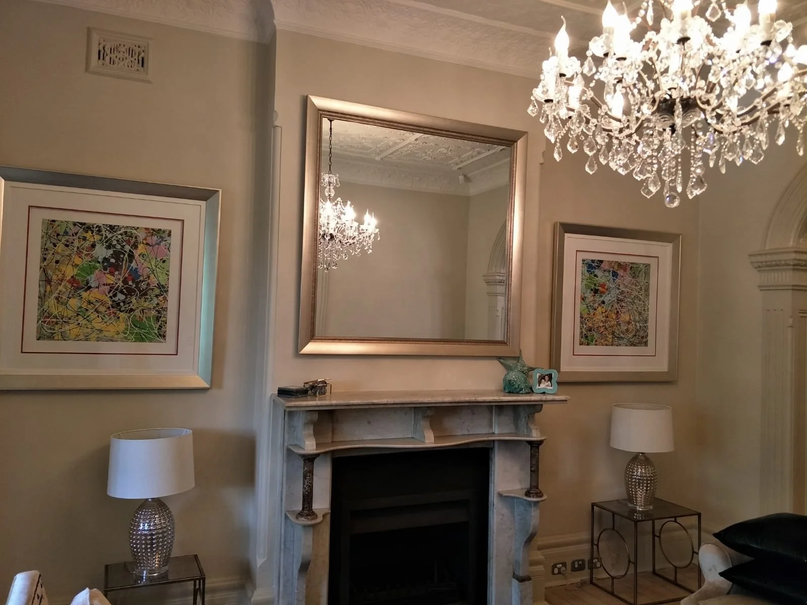 Large custom-made wall mirror with a bevelled edge and decorative silver ornate frame.
