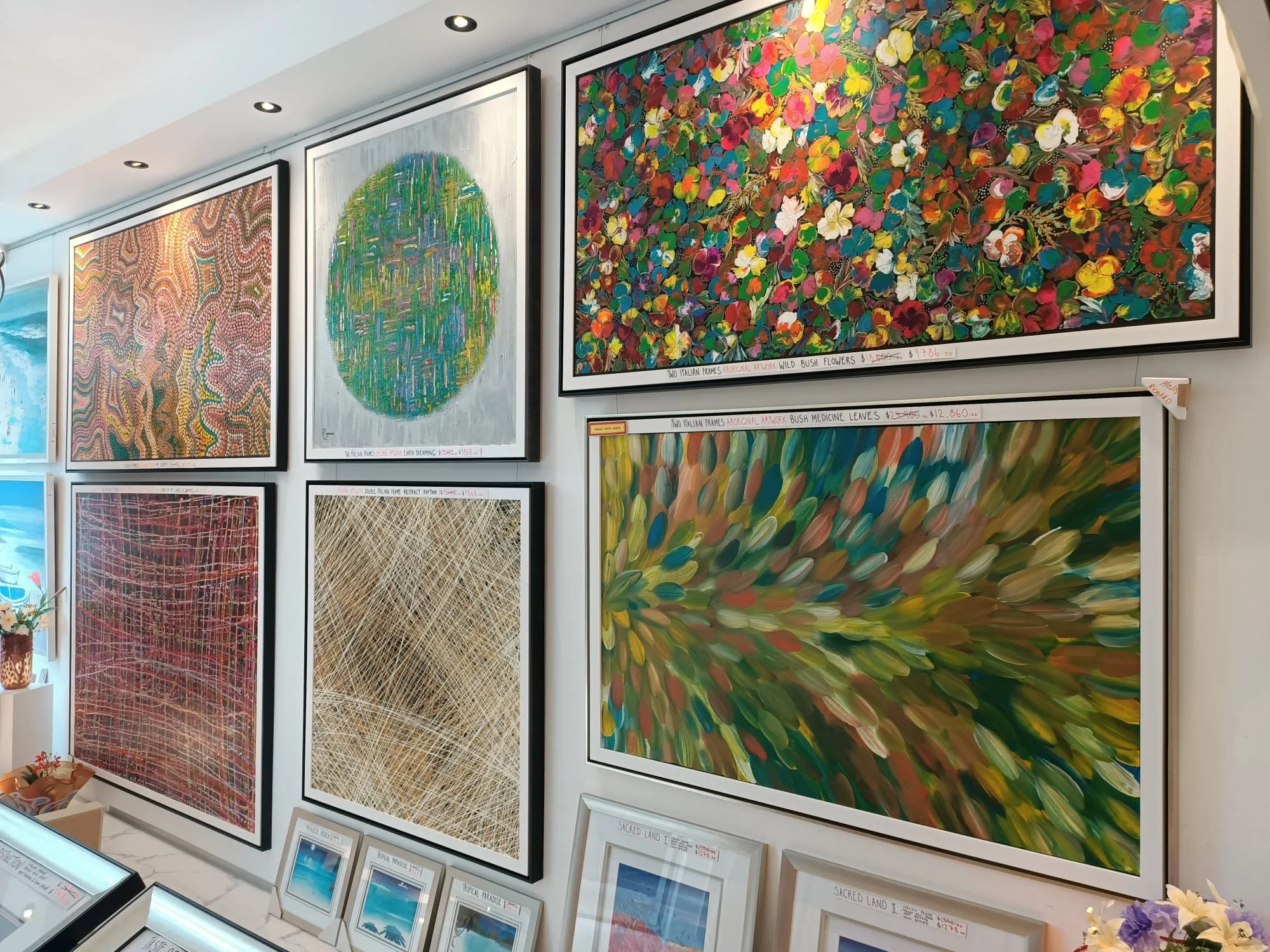 A display of original artworks and colorful canvas paintings inside the Art Reflection gallery in Mosman.