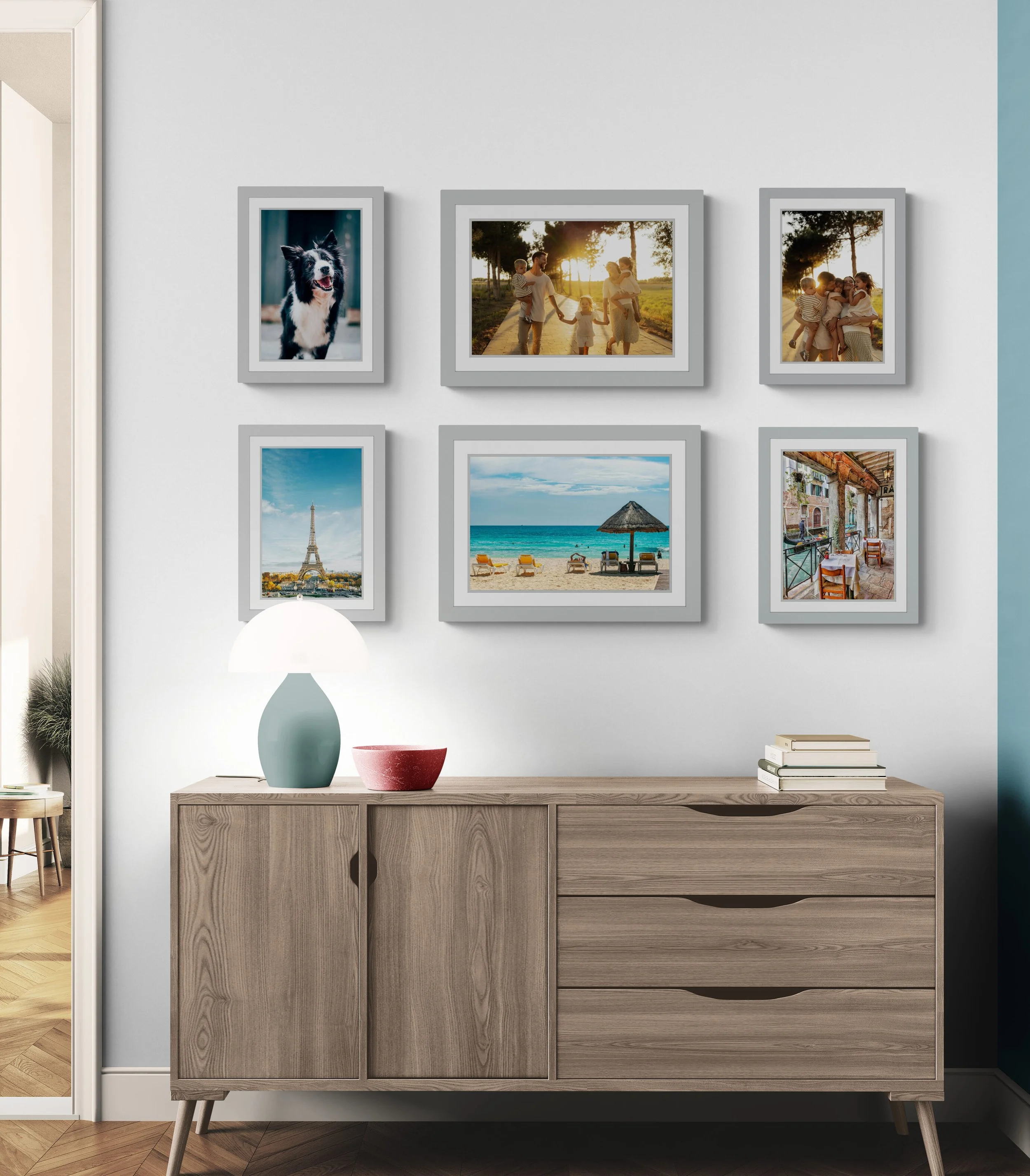 Custom framed travel and family photo gallery wall displayed above a wooden cabinet in Mosman