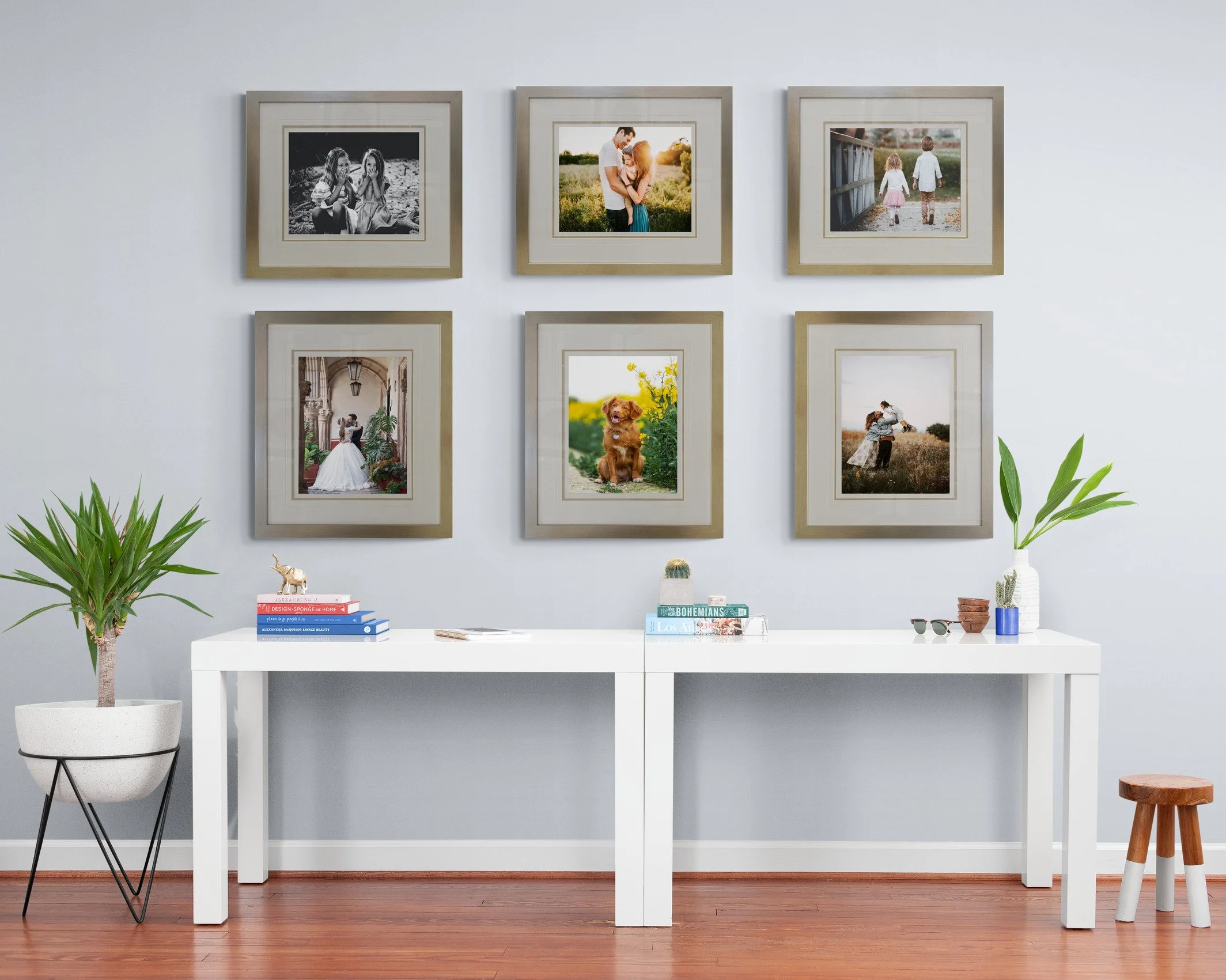 A professional gallery wall display featuring custom framed photographs and art, styled in a modern home interior by Art Reflection Mosman.