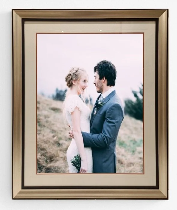 A beautiful, bespoke framed wedding photograph displayed in an elegant, modern home interior, featuring professional archival-grade framing by Art Reflection Mosman.