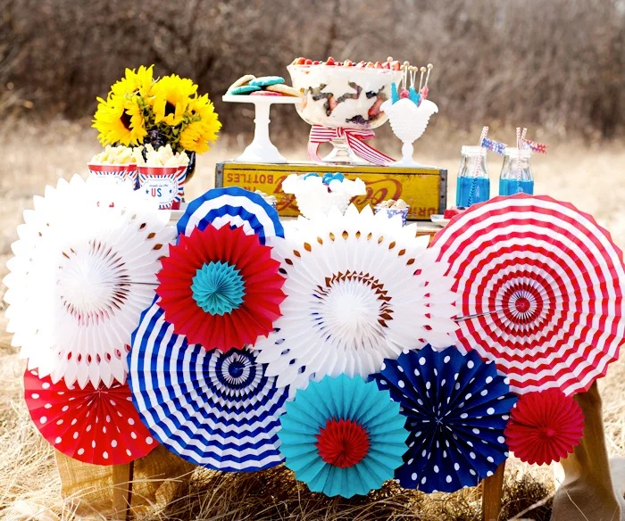 Paper pinwheels, stars and banners are great ways to add excitement and whimsy to any space. Whether you hang them from the ceiling, place them in a table setting or put them in the yard, these fun pops of color liven up all negative spaces. Many of the designs are available in the forms of free printables online!