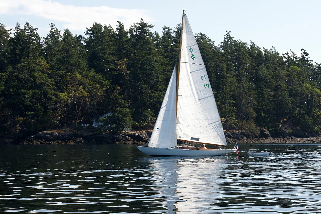 Mike Douglas ghosting in his IC one-design near West Sound