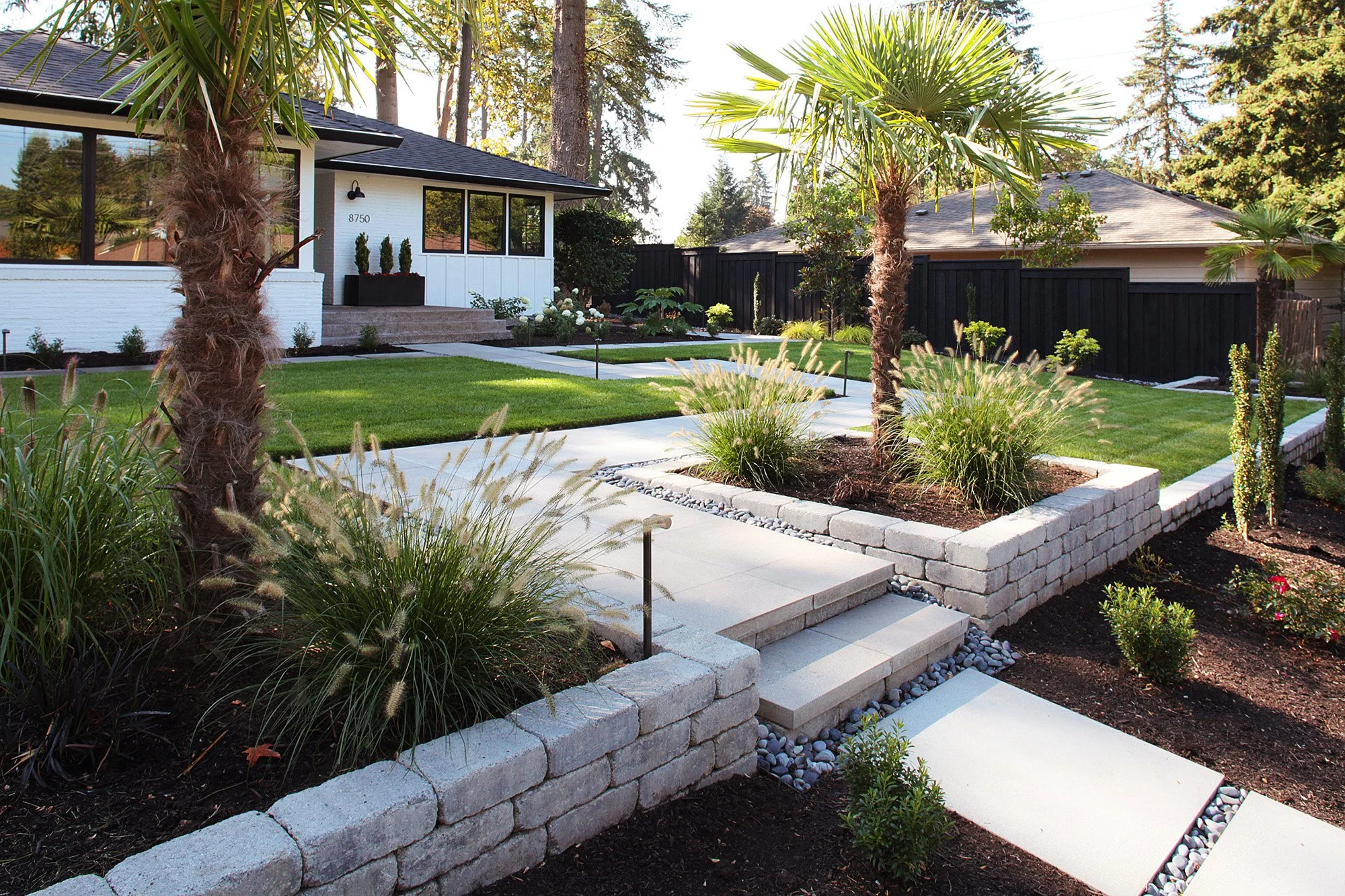Mid-Century Modern style home in Raleigh Hills, Oregon. New Belgard Weston retaining walls and planter boxes, and a zig-zag paver walkway to the front door.