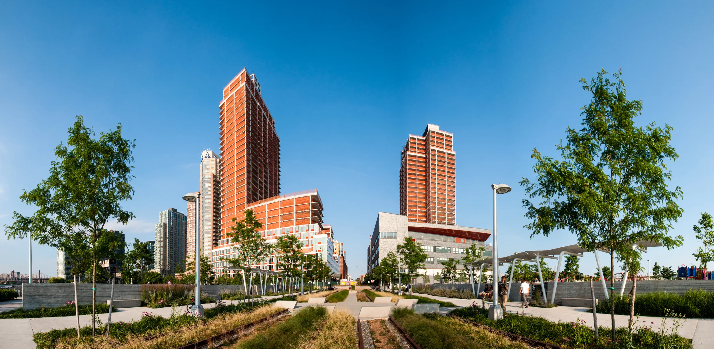 View of the west facade of Buildings A and B from Hunters Point South Park.