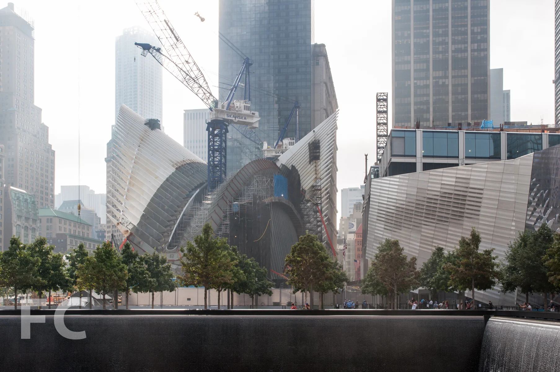 The WTC Transit Hub (center) and WTC Museum (right) seen from the Memorial pools.