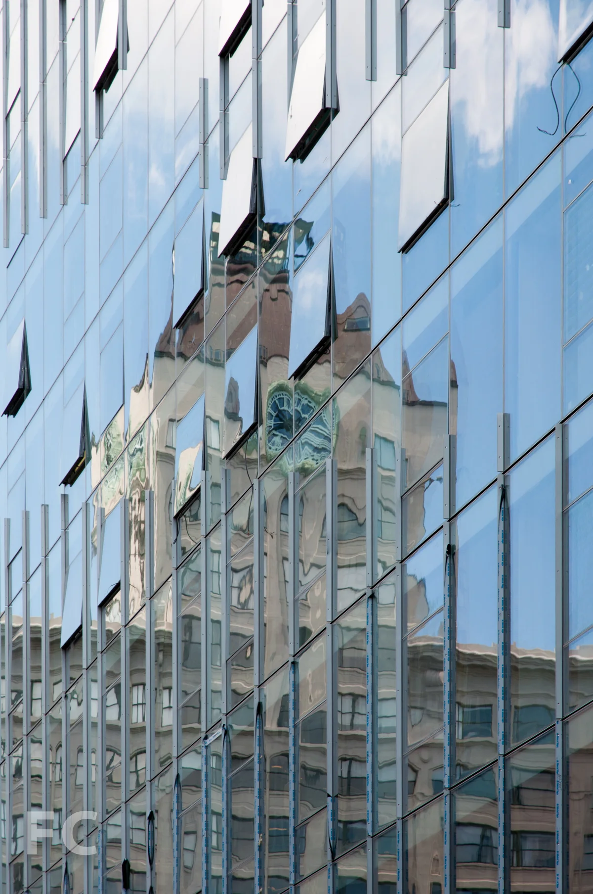 Reflection of the Clock Tower building in the curtain wall.