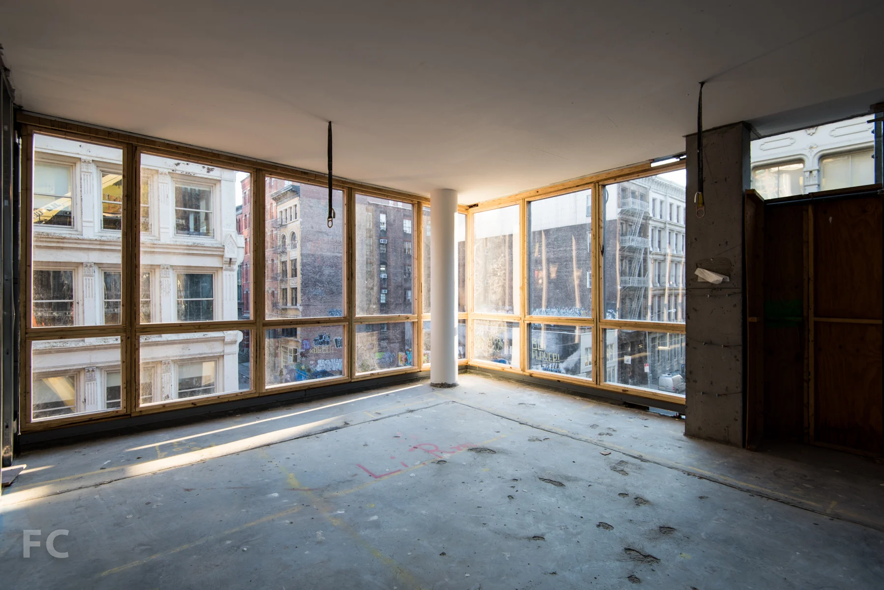 The corner living room of the B unit, looking out onto the intersection of Grand Street and Wooster Street.
