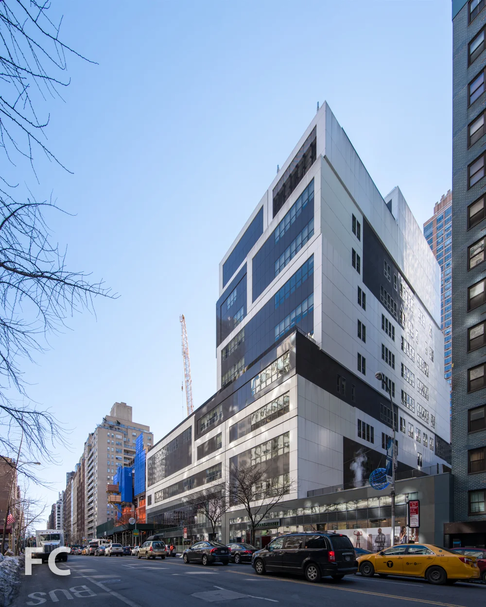 Northwest corner with earlier constructed public school and retail base (right).