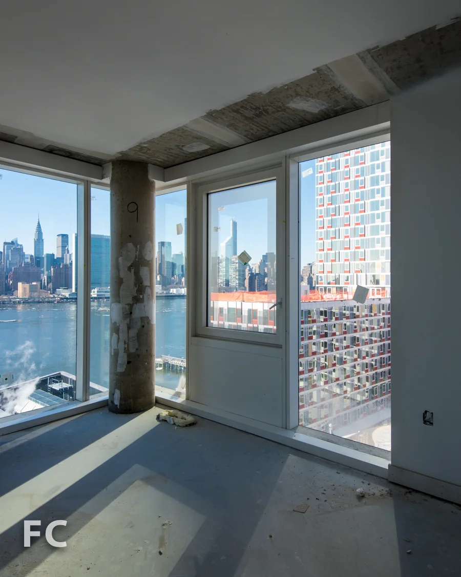View of the Manhattan skyline and Hunter's Point South Commons from a corner unit in Hunter's Point South Crossing . 
