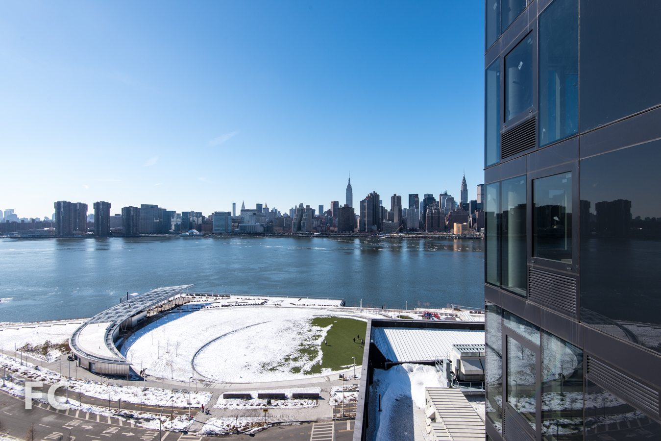 View of the Manhattan skyline and Hunters Point South park from Hunter's Point South Crossing .