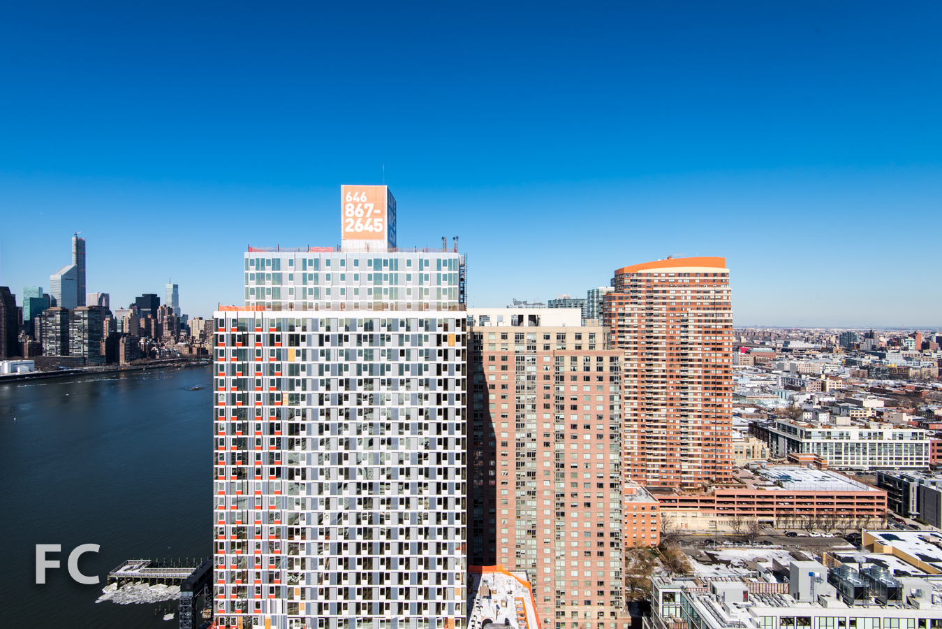 South facade of Hunter's Point South Commons (left) and the towers of Queens West (right).