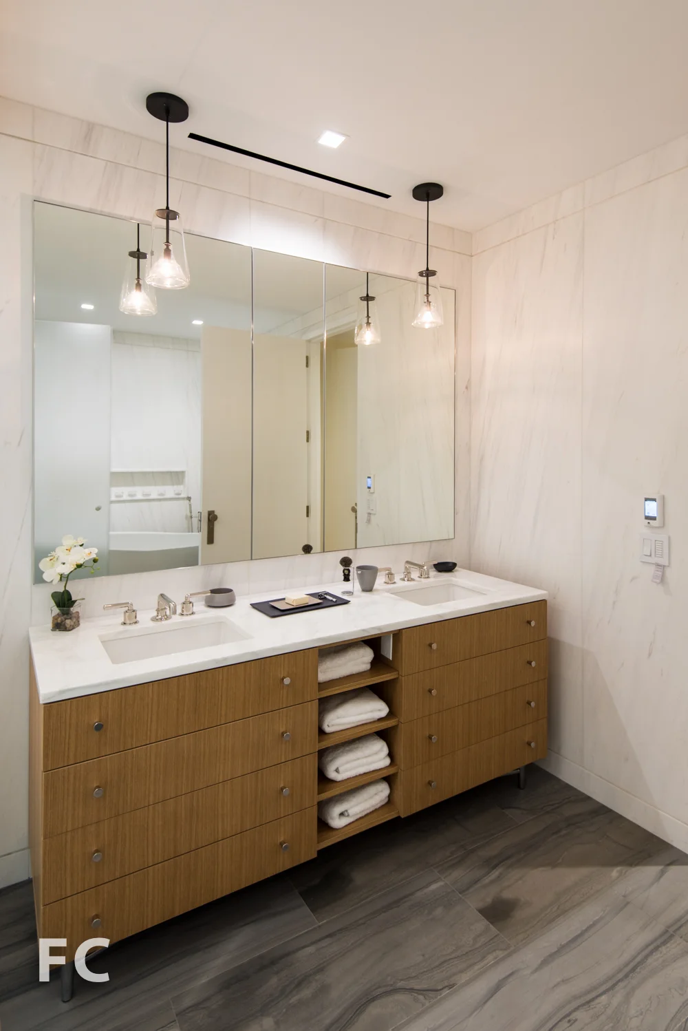 Master bathroom vanity featuring rift-cut white oak cabinetry and a countertop of polished Calacatta Borghini marble.
