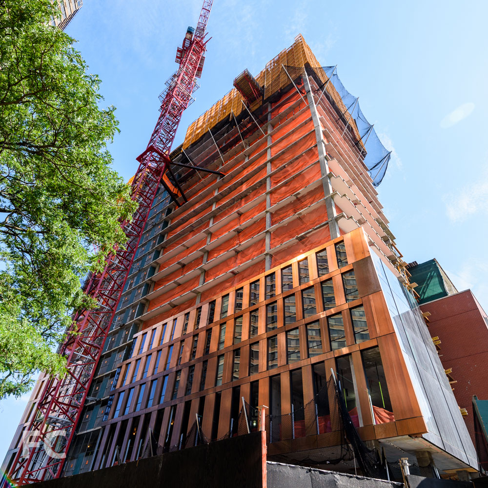 Looking up at the copper and glass north facade of the north building.