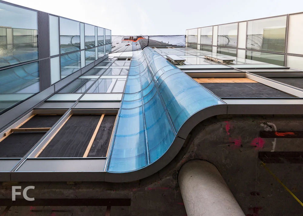 Looking up at the curved glass element on the north façade.