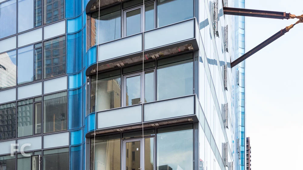 A detail of the integrated curved façade element and balconies.