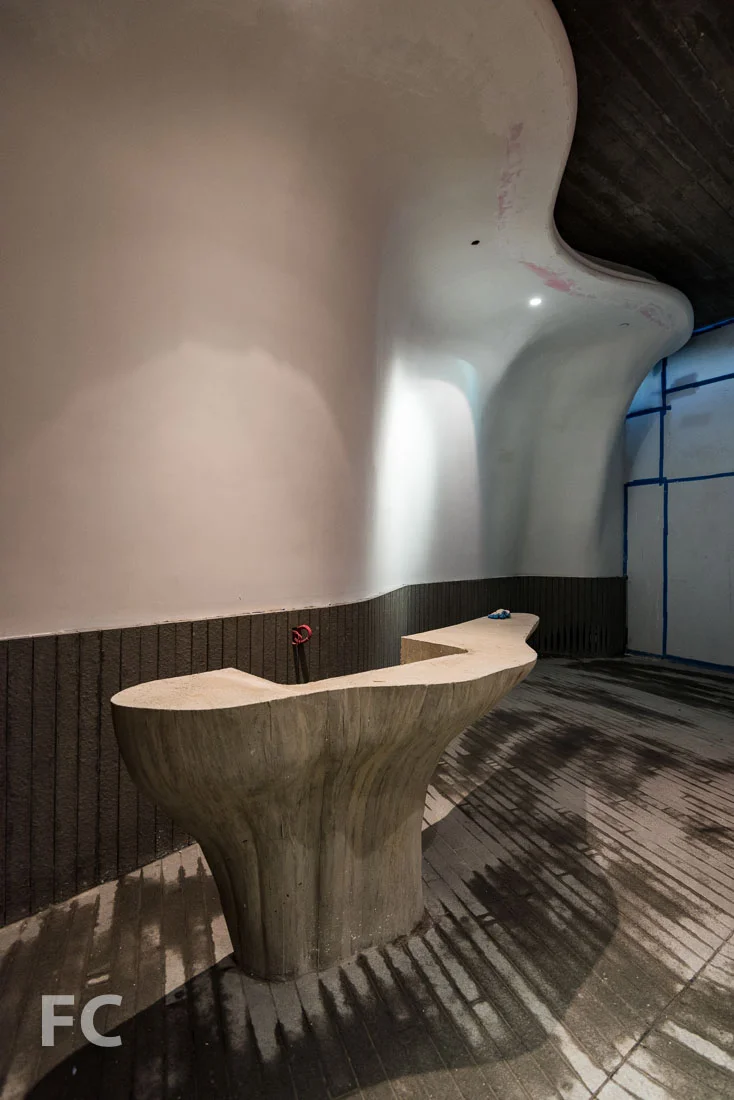 Residential lobby and concierge desk under construction.
