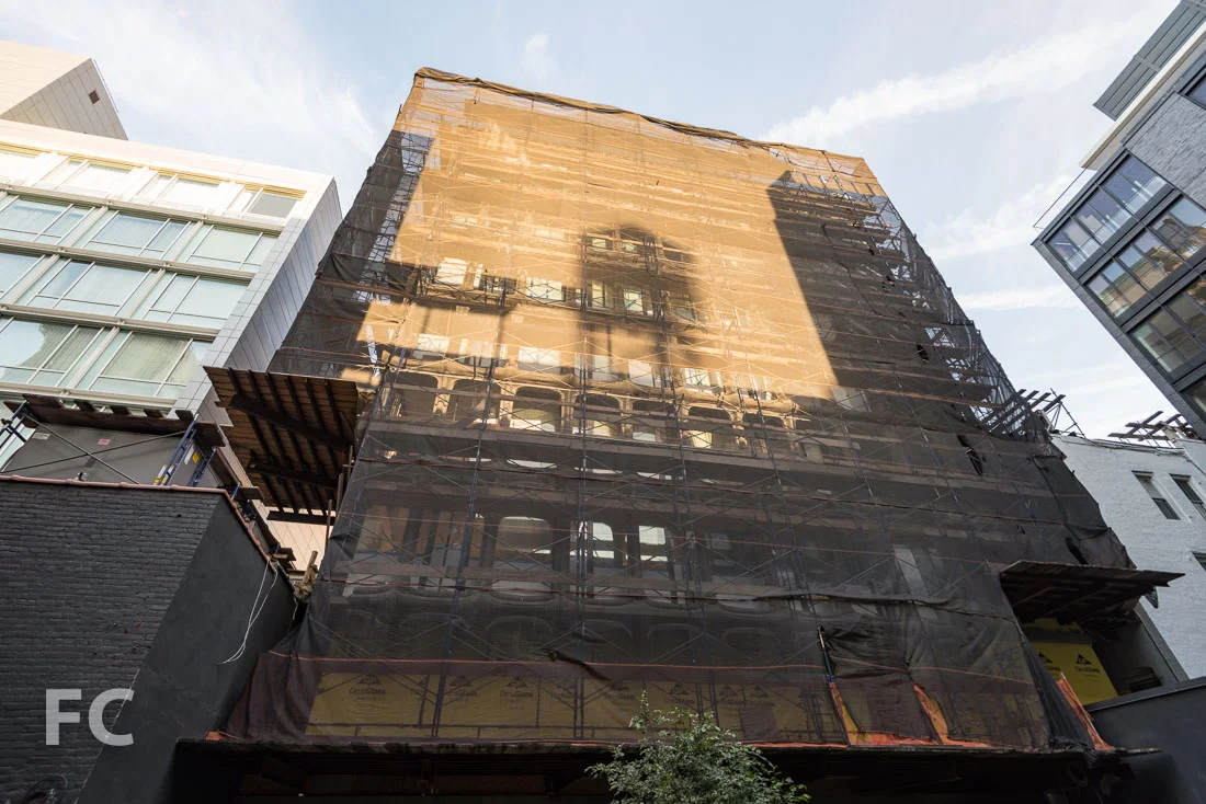 Courtyard facade still under construction scaffolding.