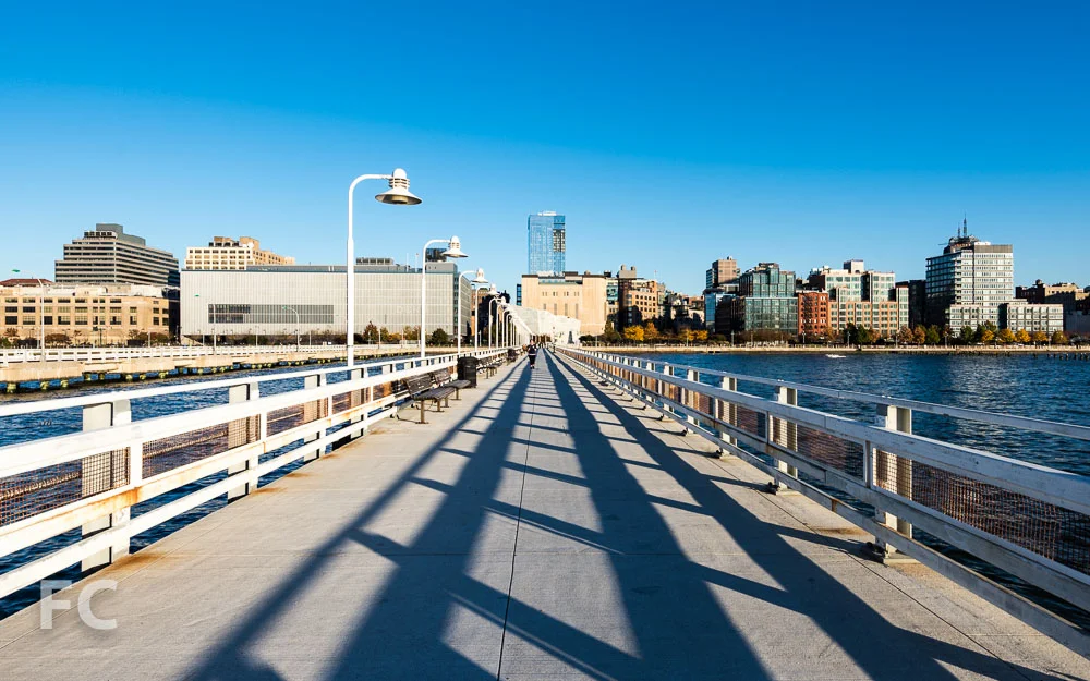 Looking east toward the Manhattan Districts 1/2/5 Garage (left) and the Salt Shed (right) from Pier 34 at Hudson River Park.