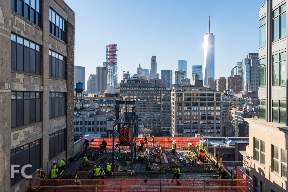 Workers prepare the 15th floor slab of the Vandam Street tower.