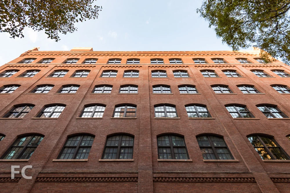 Looking up at the east facade from Mott Street.