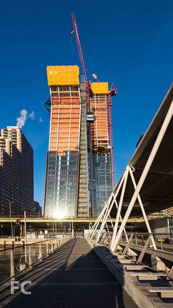 East facade of the north (right) and south (left) towers from the East River Ferry terminal at East 35th Street.