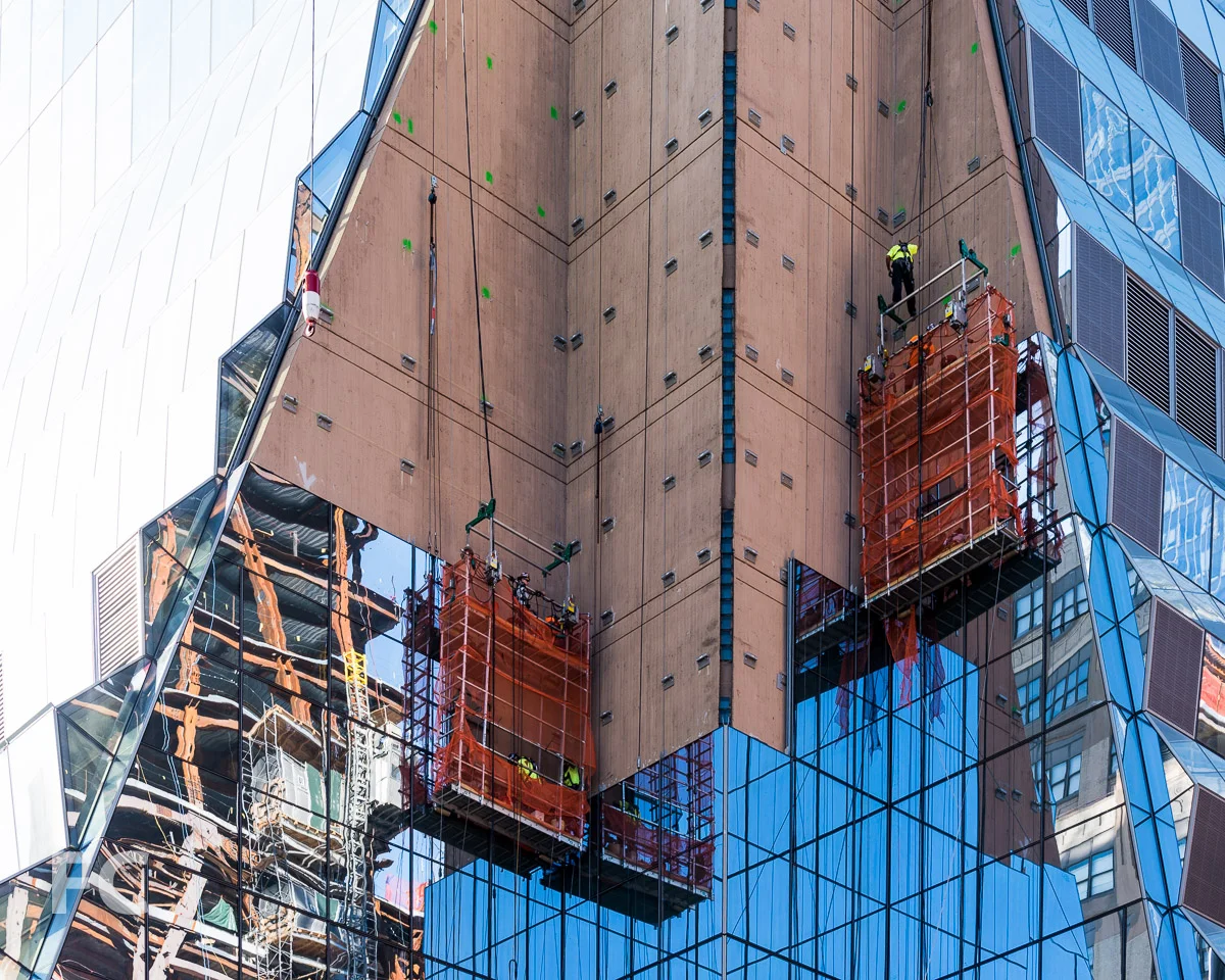 Glass curtain wall panels going up at the northwest corner pier.