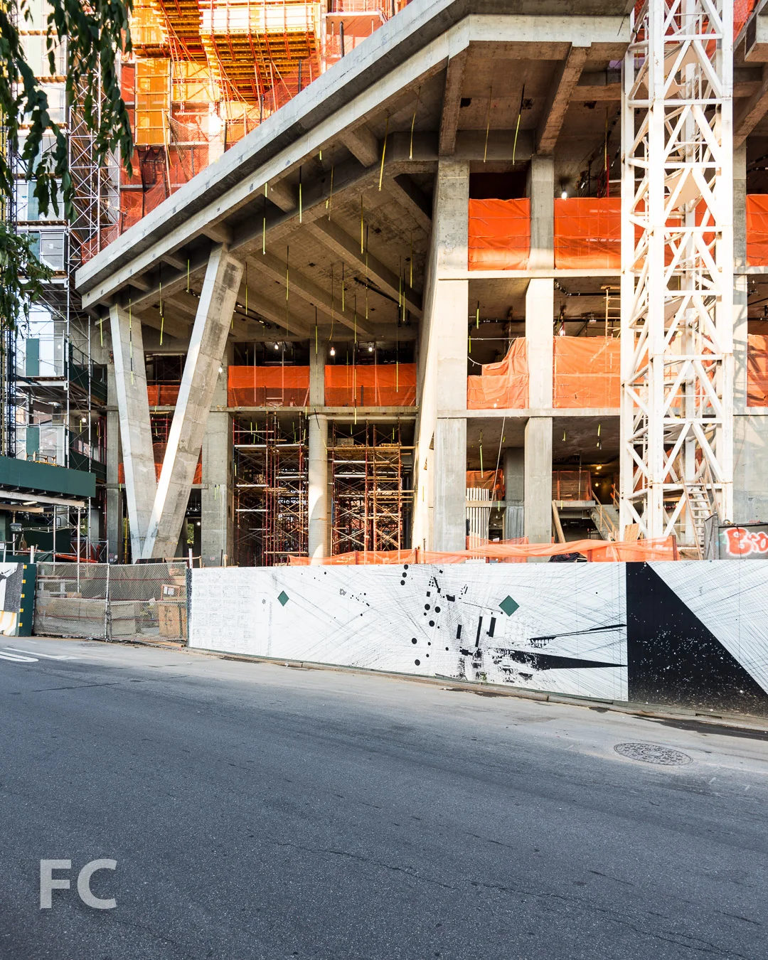 West elevation with construction shed artwork along Pike Slip.