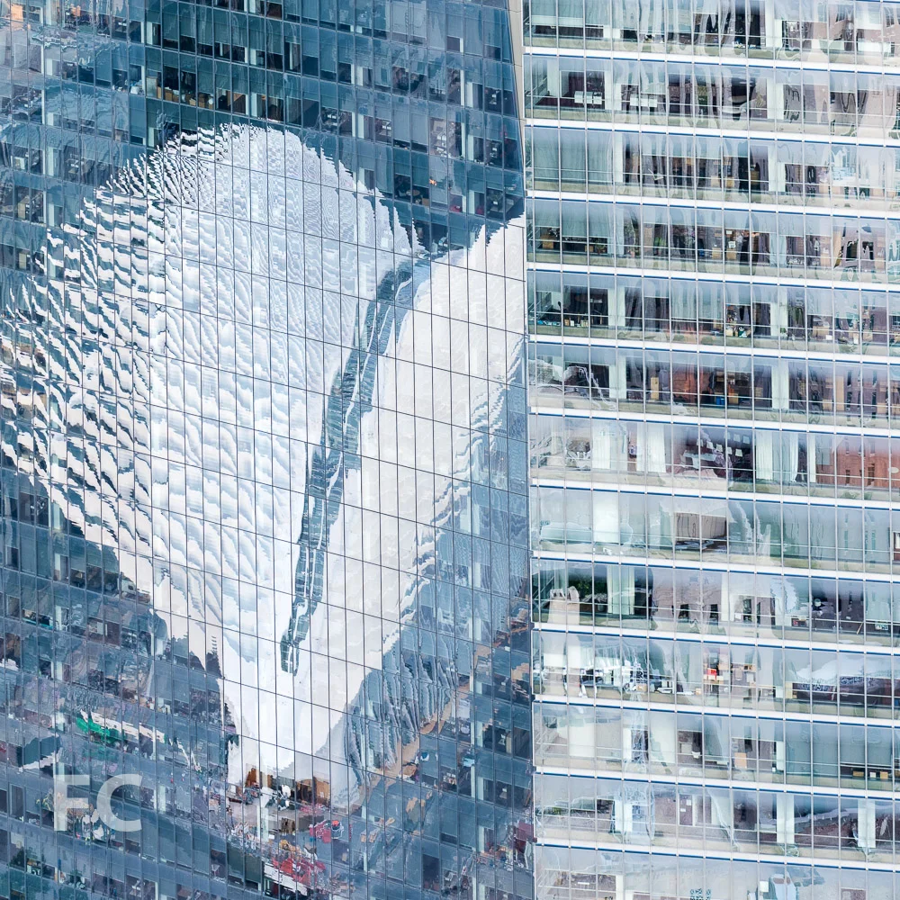 World Trade Center Transportation Hub reflected in the facade of 1 World Trade Center.